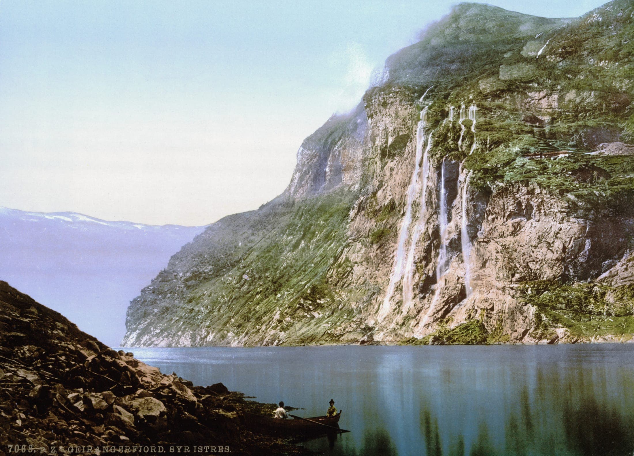 The Seven Sisters waterfall cascading down cliffs into Geirangerfjord, Norway