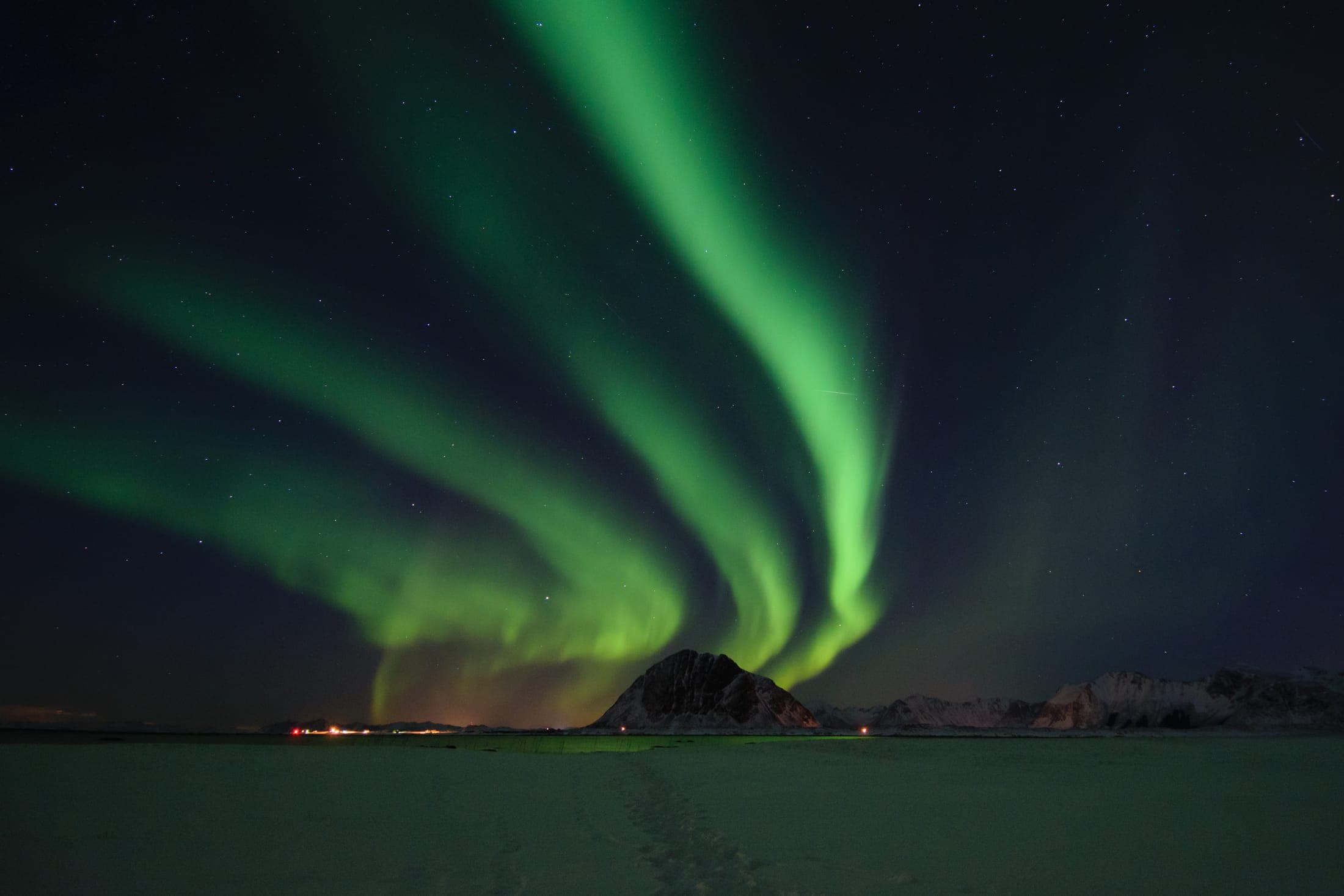 Dramatic jagged mountain peaks rising above the coastline in the Lofoten Islands, Norway