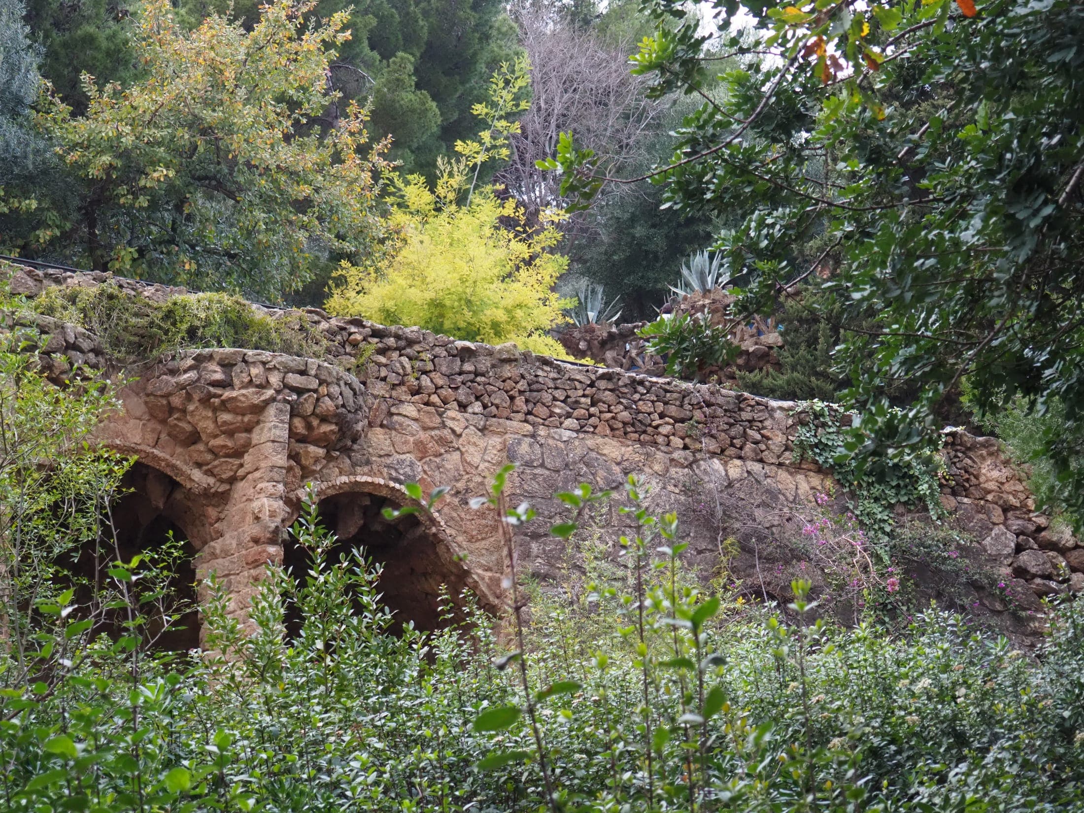 Gaudí's mosaic terrace and colorful architecture at Park Güell, Barcelona, Spain