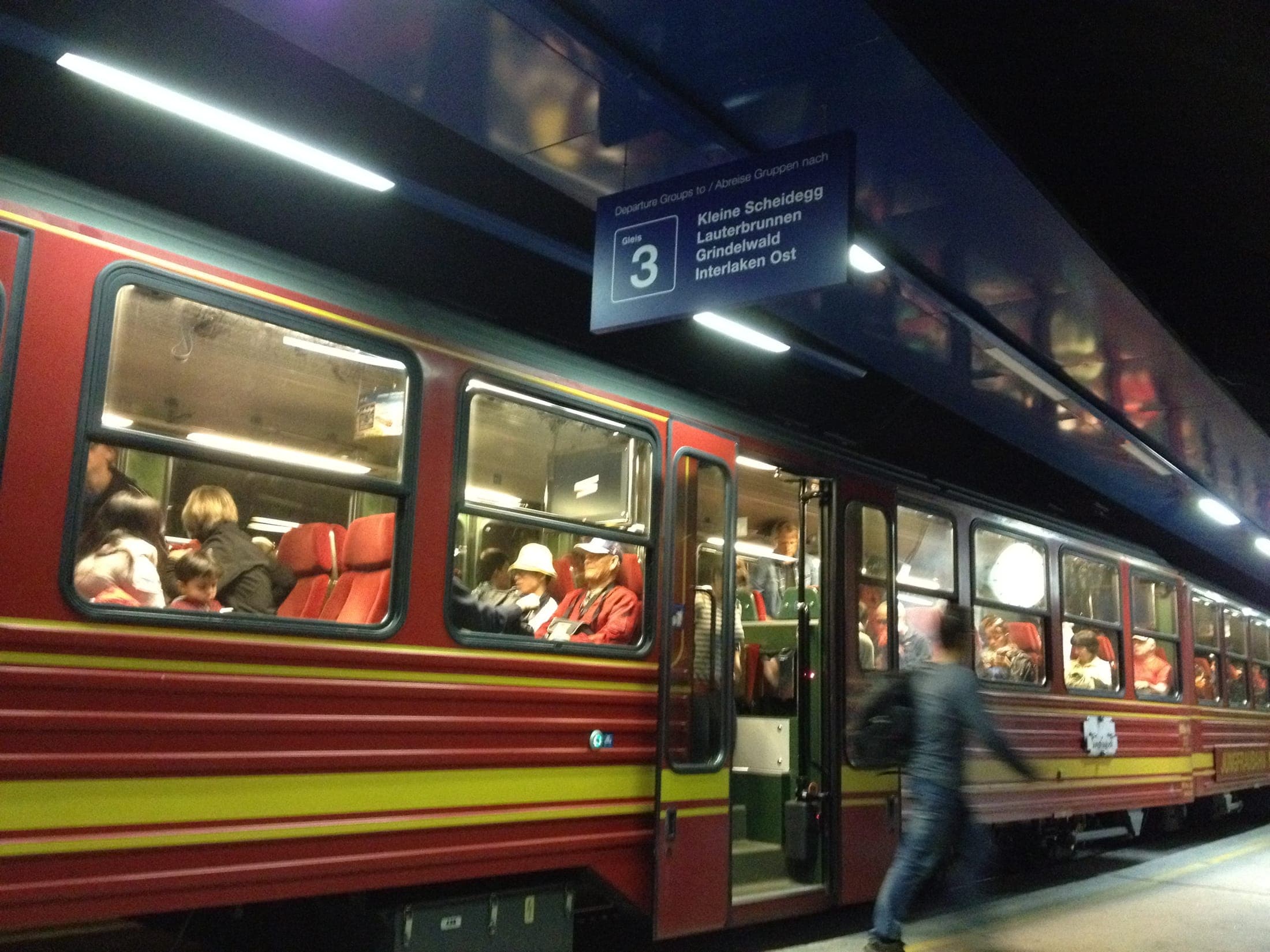 Jungfrau Railway train at Jungfraujoch station amid snowy peaks, Switzerland