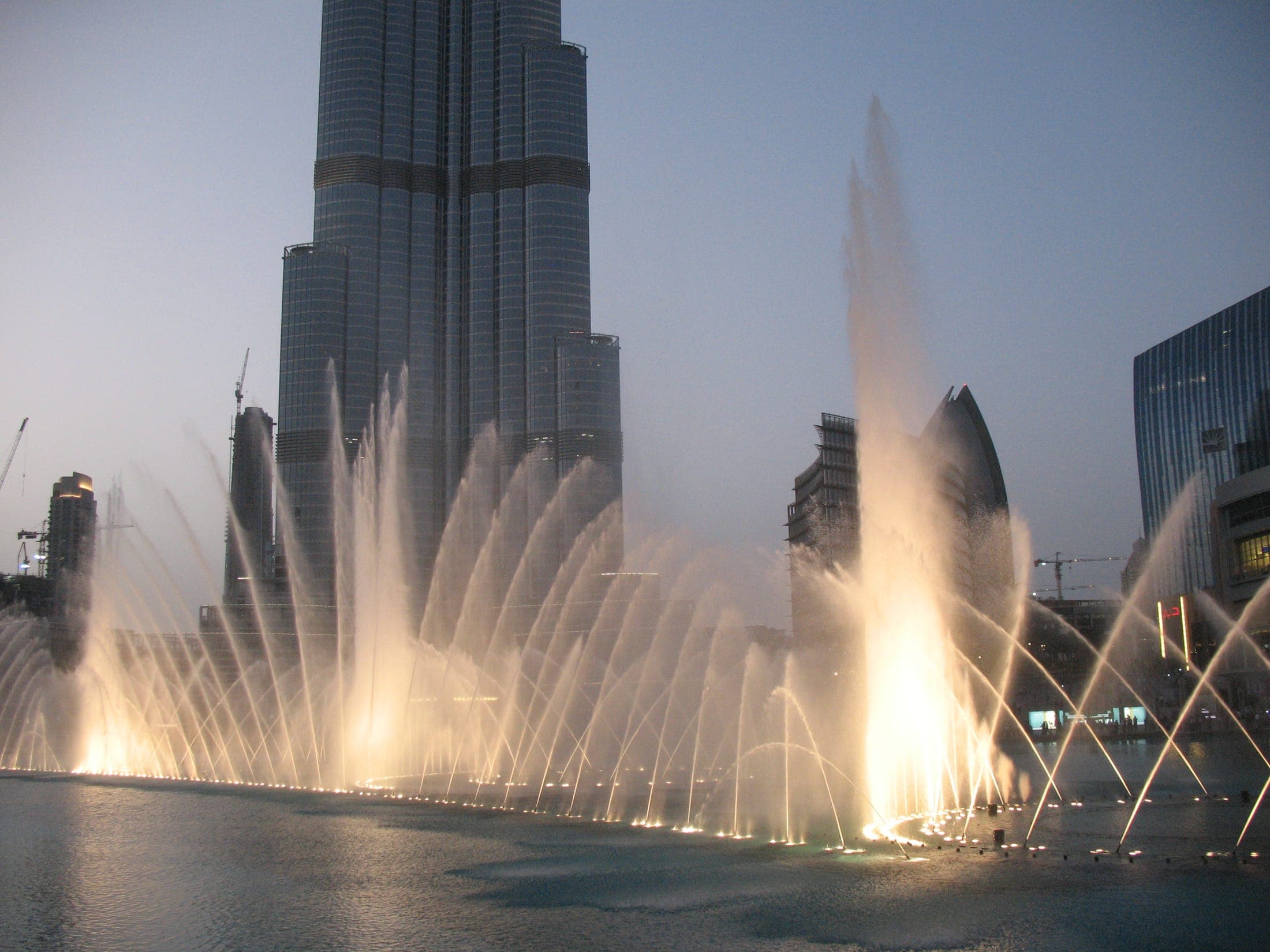 The Dubai Fountain performing its water jet show in front of Dubai Mall and Burj Khalifa